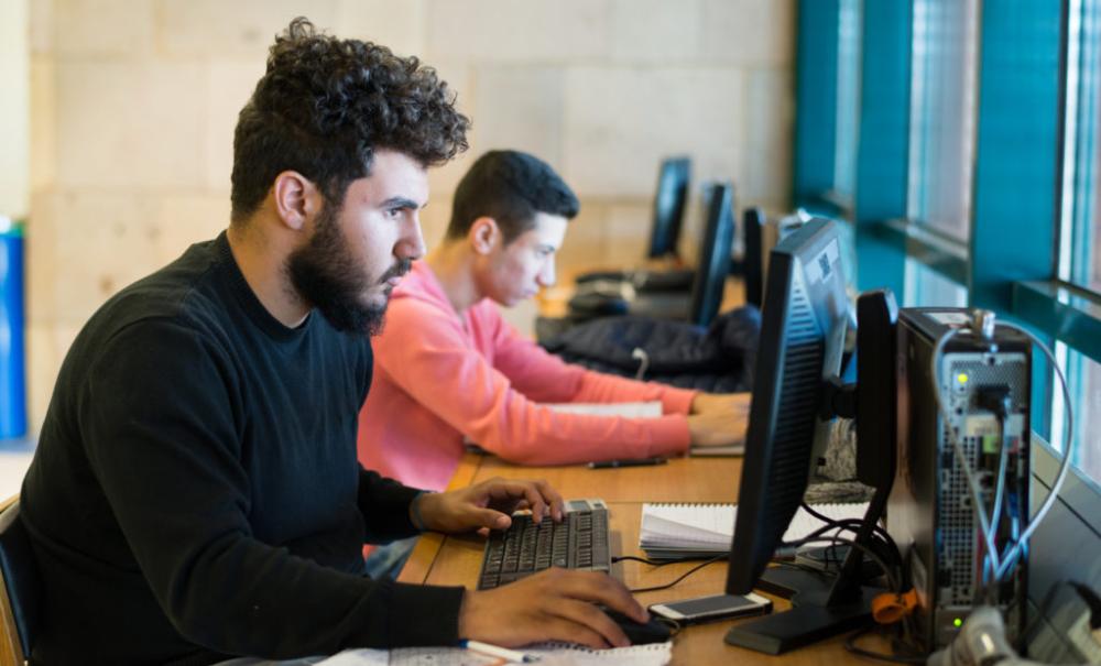 AUC students on the computers in the library 